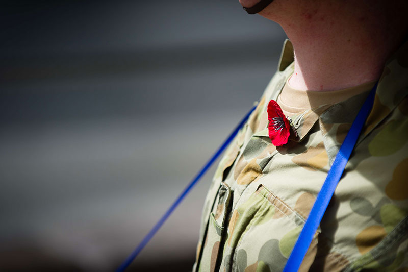 An Australian solider wears a poppy on Remembrance Day