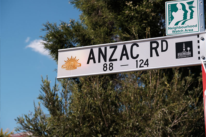 ANZAC Road street sign in Brisbane displaying the Australian Army Rising Sun insignia.