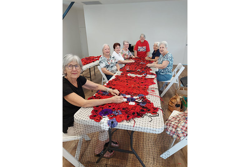 Sandgate QCWA Branch members constructing the panels of hand-crafted poppies